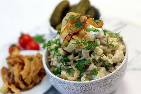 Home-made spaetzle noodles with aubergine sauce and crispy onion rings